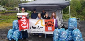 Group smiling at bottledrive fundraiser