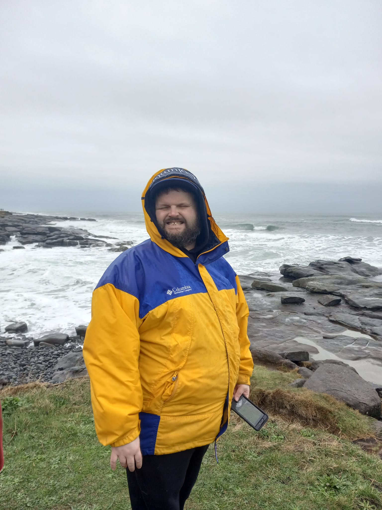 The Arc of Lincoln County Participant DJ stands at the beach